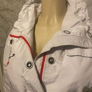 Women’s lightweight waterproof 3/4 jacket, cream with orange detailing.